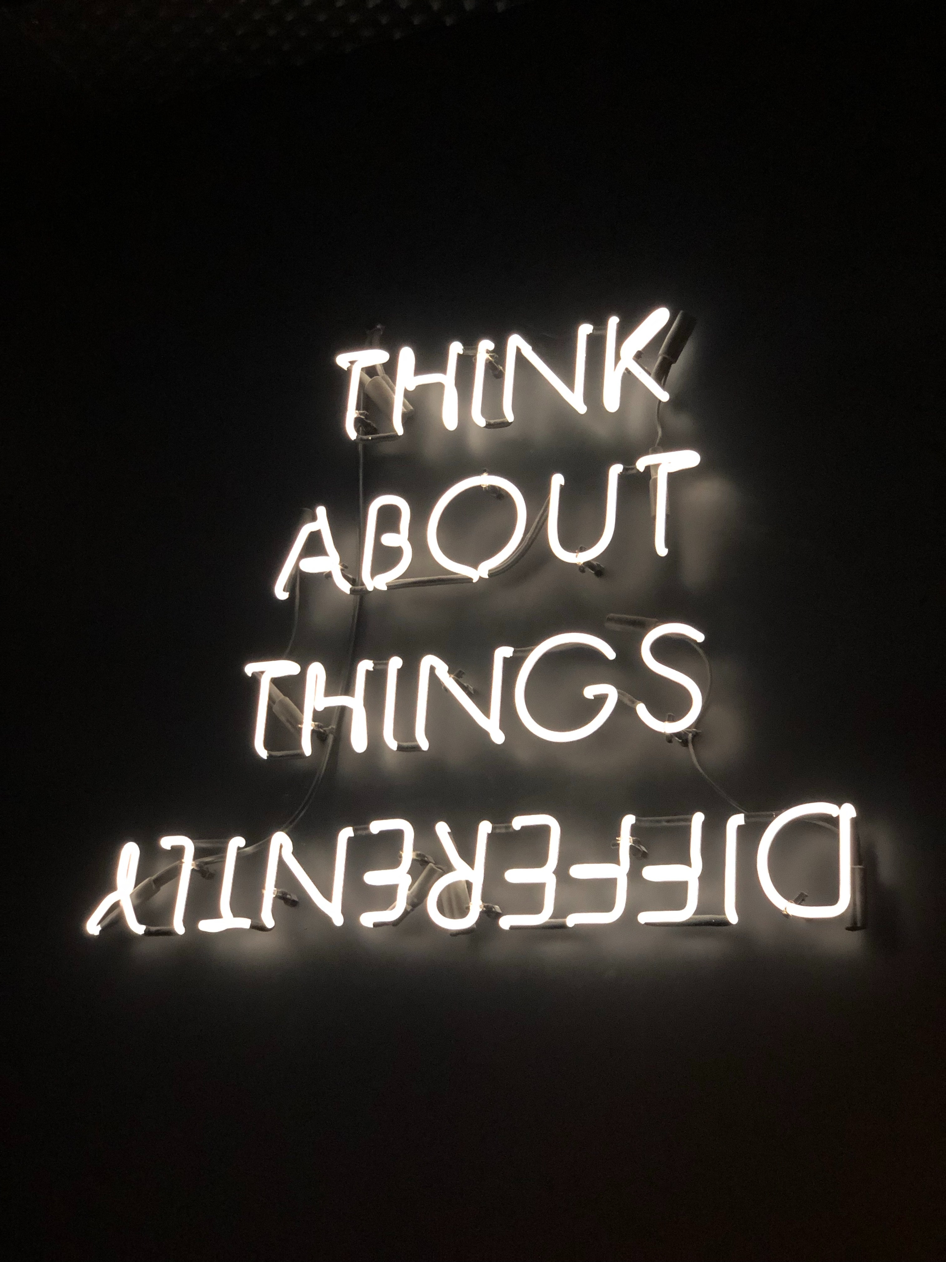 Neon lights which say 'Think about things differently'